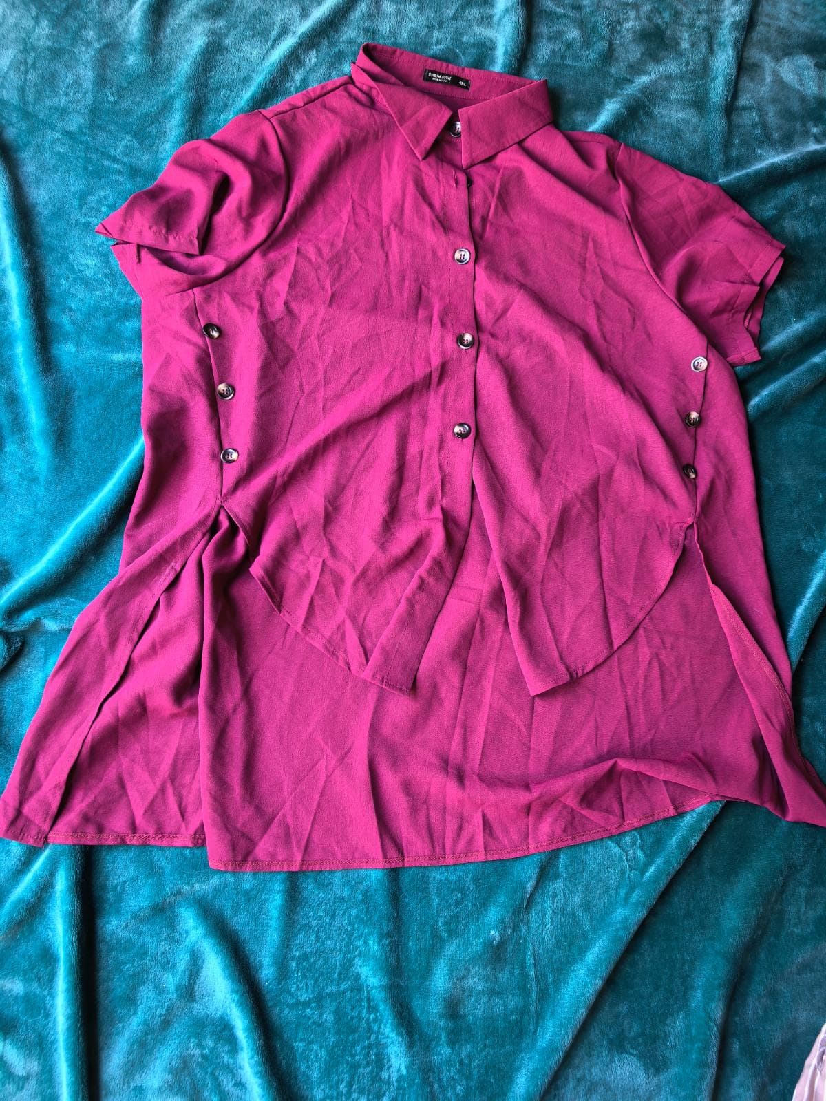 Magenta short sleeve button-front high-low blouse